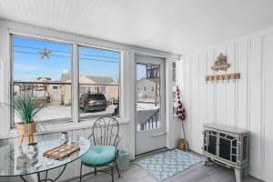 a balcony with a glass table and chairs and a window at Blue Chill in Hampton