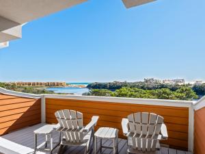 two chairs on a balcony with a view of the ocean at Sanctuary at Redfish 3119 by Newman-Dailey in Santa Rosa Beach