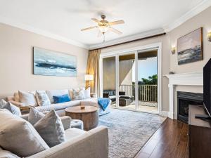 a living room with a couch and a fireplace at Sanctuary at Redfish 3119 by Newman-Dailey in Santa Rosa Beach