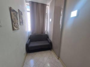 een kamer met een stoel in de hoek van een kamer bij SUH Copacabana 143 in Rio de Janeiro