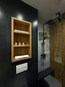 a bathroom with a shower and a sink and a shower at Elmax Aparthotel in Craiova