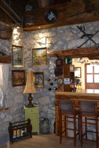 a room with a stone wall with a table and chairs at Peuta Hill in Podgorica