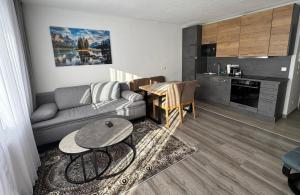 a living room with a couch and a table at Appartement Sami in Altenmarkt im Pongau