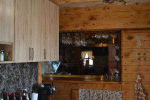 a kitchen with wooden cabinets and glasses on the counter at Peuta Hill in Podgorica +31 photos