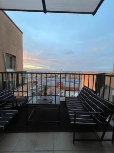 ein Balkon mit Stühlen, einem Tisch und Meerblick in der Unterkunft Arena Royal Suite in Bacău
