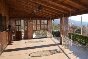 a patio with two chairs and glass doors on a building at Peuta Hill in Podgorica