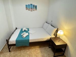 a small bedroom with a bed with towels on it at Dimado Family in Kavála