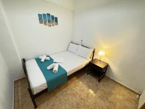 a small bedroom with a bed with towels on it at Dimado Family in Kavála +15 photos