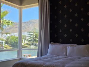 a bedroom with a bed and a large window at Heaven in Cape Town