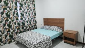 a bedroom with a bed and a curtain with birds on it at Meeting Point Hostels-Praia Beachwalk-NO CASH ACCEPTED-Also in Fogo & Tarrafal in Praia