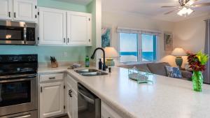 a kitchen with white cabinets and a counter top at Captains House A3 in Fernandina Beach