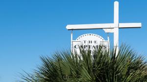 a white cross on top of a palm tree at Captains House A3 in Fernandina Beach