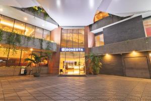 a building with a courtyard in front of it at Sonesta Hotel Cali in Cali