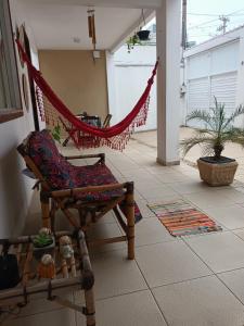 a hammock in a living room with at Mandalas Guest House in Cabo Frio