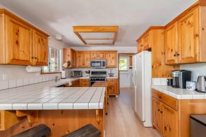 a kitchen with wooden cabinets and a white refrigerator at Sierra Sanctuary in Dorrington