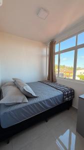 En eller flere senge i et værelse på Flamingo Pé na areia - Centro/Guaratuba