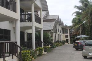 a row of houses with cars parked on a street at Shalini Garden Hotel & Apartments in Singatoka