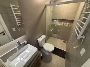 a bathroom with a shower and a toilet and a sink at Estúdios Completos no Centro de Floripa - CMA in Florianópolis +36 photos