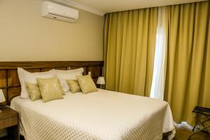 מיטה או מיטות בחדר ב-Hotel Gramado Interlaken