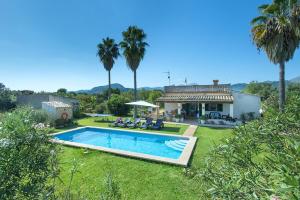 a house with a swimming pool in a yard at Villa Punta Magdalena in El Port