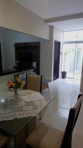 una sala da pranzo con tavolo e sedie e un soggiorno di Casa Buritis a Primavera do Leste