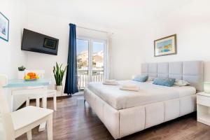 un soggiorno bianco con letto e finestra di Guest House Kovacevic a Hvar