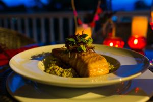 a plate with a piece of food on a table at Hotel Boutique El Triángulo in Armenia +144 photos