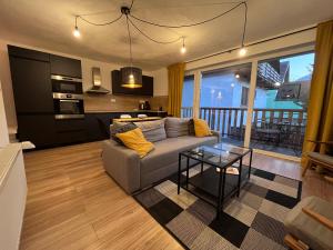 a living room with a couch and a table at Nordic House in Závažná Poruba