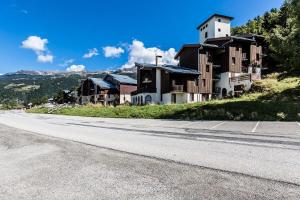 an empty road in front of houses on a hill at CHALET DE MONTCHAVIN - Studio pour 4 Personnes MAE-9193 in Montchavin