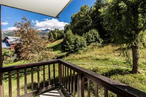 a view from the balcony of a house with trees at CHALET DE MONTCHAVIN - Studio pour 4 Personnes MAE-9193 in Montchavin +2 photos