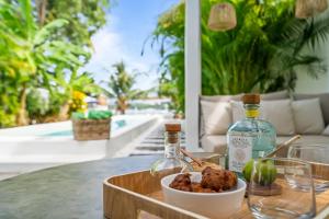 a table with two bottles of wine and a bowl of food at Casa Blanca in La Trinité