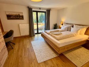 a bedroom with a large bed and a window at Landhaus Barbara in Kitzbühel