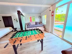 a ping pong table in the middle of a room at Casa Vagon Isla Bendita 2 in La Gonzalez