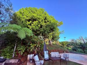 a group of chairs and an umbrella next to a pool at Casa Vagon Isla Bendita 2 in La Gonzalez
