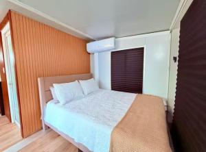 a bedroom with a large bed and an orange wall at Casa Vagon Isla Bendita 2 in La Gonzalez +18 photos