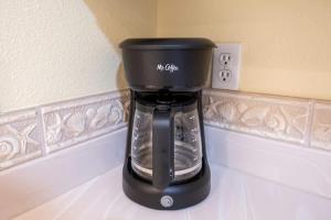 a black coffee maker sitting on a counter at The Terraces #202-Condo - Pool in Fernandina Beach
