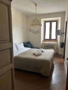 a bedroom with a bed and a chair and a window at Colle House in Rivisondoli +32 photos