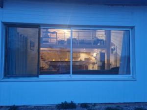 a window of a house with a blue light at Loft in Aujeurres