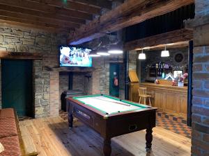 a room with a pool table and a tv at The Lanterns Hotel in Tarbert