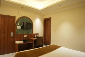 Ένα ή περισσότερα κρεβάτια σε δωμάτιο στο Hotel Jasraj Inn