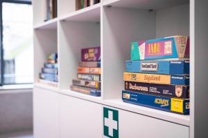 a stack of books on a shelf in a library at Spreeblick Studio Design-Loft mit Terrasse & Parkplatz in Berlin