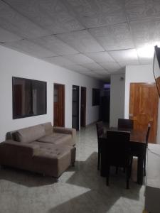 a living room with a couch and a table at Apto central 3 hab in Apartadó