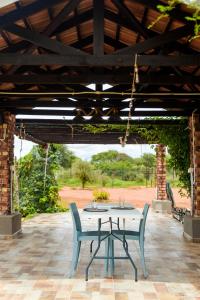 a table and two chairs on a patio at charming retreat in Gaborone