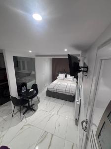 a bedroom with a bed and a table and a chair at corly1 in Vétraz-Monthoux