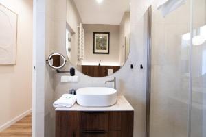 a bathroom with a sink and a mirror at Laguna Beskidów Resort - Desert Spring in Zarzecze +9 photos
