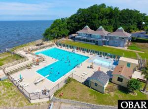 an aerial view of a swimming pool next to the ocean at Ocean Pearl in Kill Devil Hills