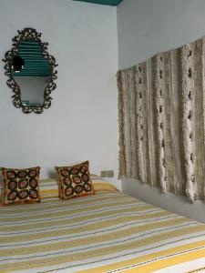 a bedroom with a bed and a mirror on the wall at Dar el Marsa in Tangier