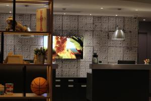 a room with a tv and a basketball on a wall at Campanile Shanghai Bund Hotel in Shanghai