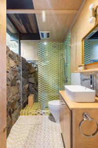 a bathroom with a shower and a toilet and a sink at Two Creeks Treehouse in Mill Valley +51 photos