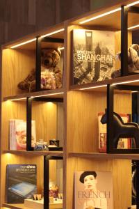 a book shelf filled with lots of books at Campanile Shanghai Bund Hotel in Shanghai